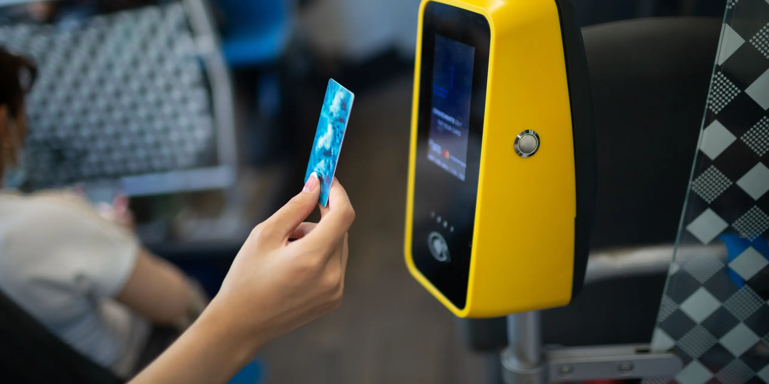 Person paying bus fare on tap to pay module