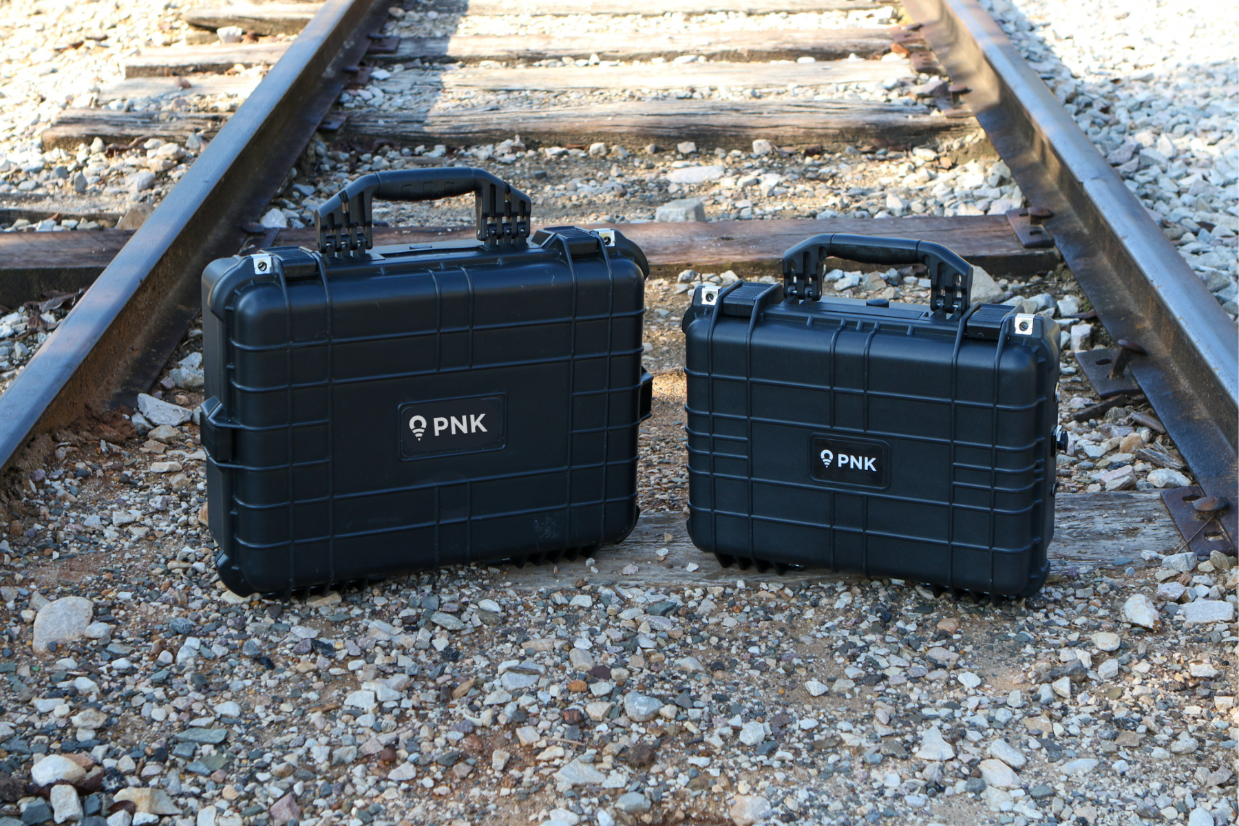 Two PNKs sitting on railroad tracks